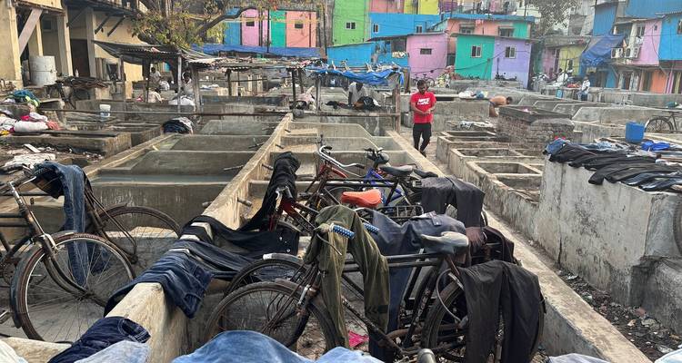 Outdoor laundry area with colorfully painted buildings.