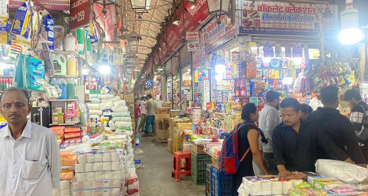 Bustling market filled with various goods and customers.