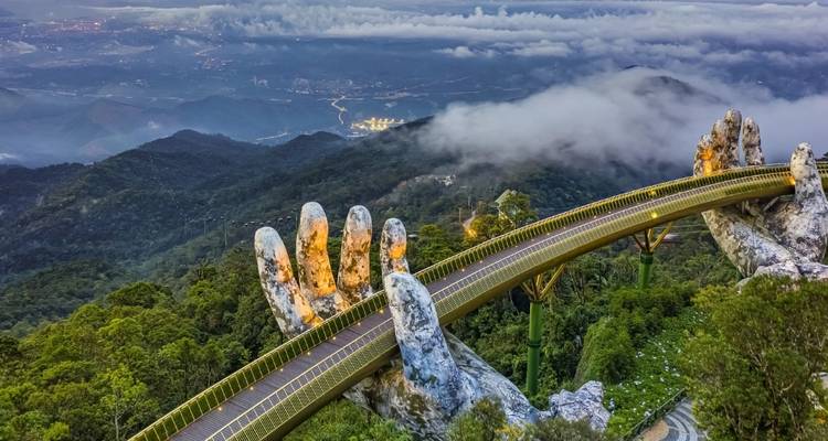 Golden Bridge held by giant stone hands above the clouds.