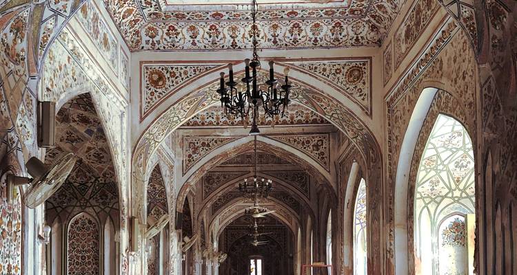 Ornately decorated hallway with chandeliers.