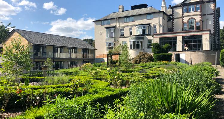 Modern garden design around a historic building.