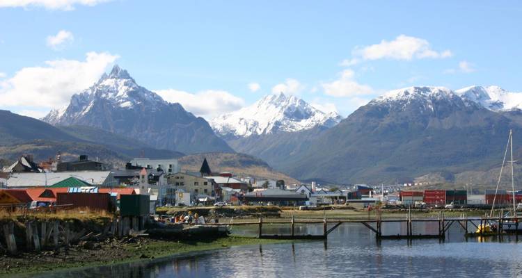 Harbor town with mountain backdrop.