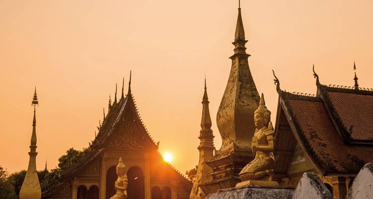 Temple with pointed roof structures during sunset