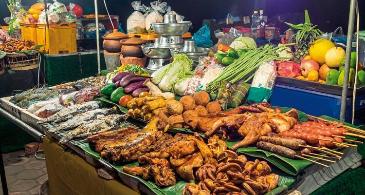Street food market with a variety of dishes at night