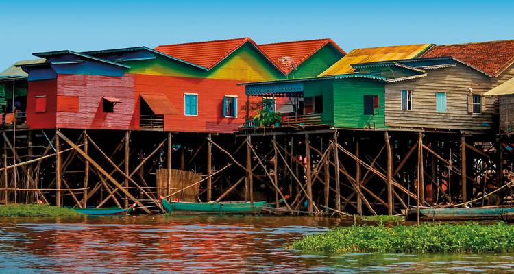 Colorful stilt houses along a river.