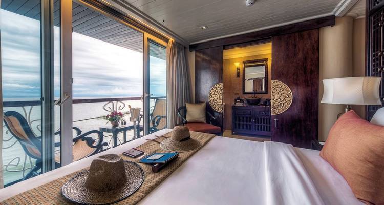 Luxurious bedroom interior with river view on a cruise ship.