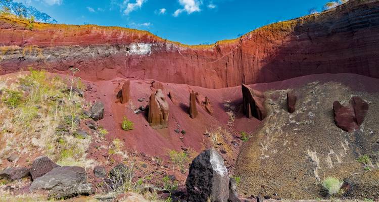 Colorful sediment layers in a volcanic crater landscape.
