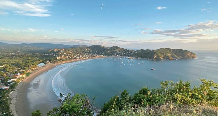 Aerial view of San Juan Del Sur bay with boats and beach.