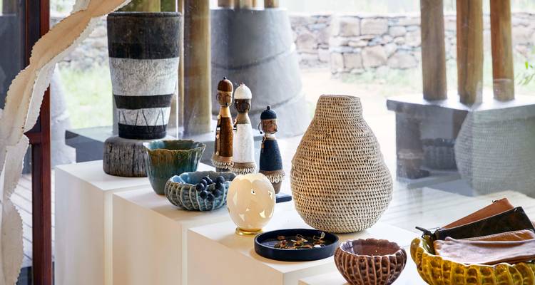 Interior display of handcrafted bowls and figurines.