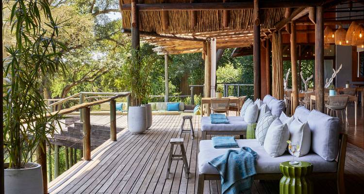Outdoor seating area with comfortable chairs and views of greenery.