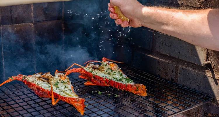 Grilled seafood being cooked on an outdoor barbecue.