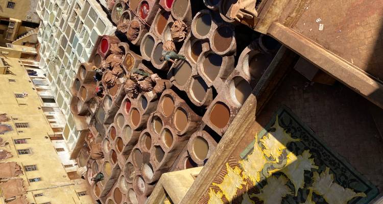 Tannery with numerous colorful vats in a traditional setting.
