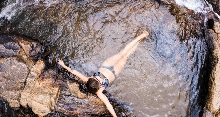 Persoon die ontspant in een rotsachtige beek.