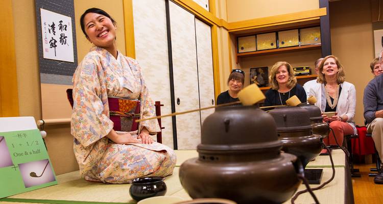 Japanese tea ceremony with participants in traditional attire.