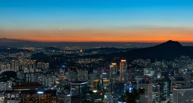 Cityscape view with buildings at sunset.