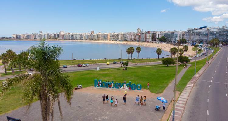 Aerial view of Montevideo with tourists near the iconic sign.