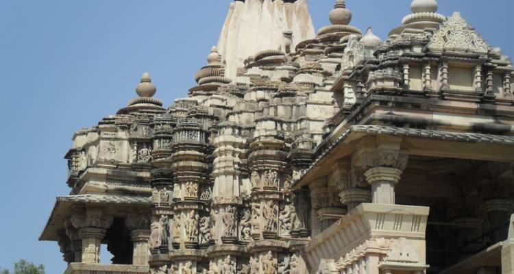 View of an intricately carved stone temple with spires and domes.