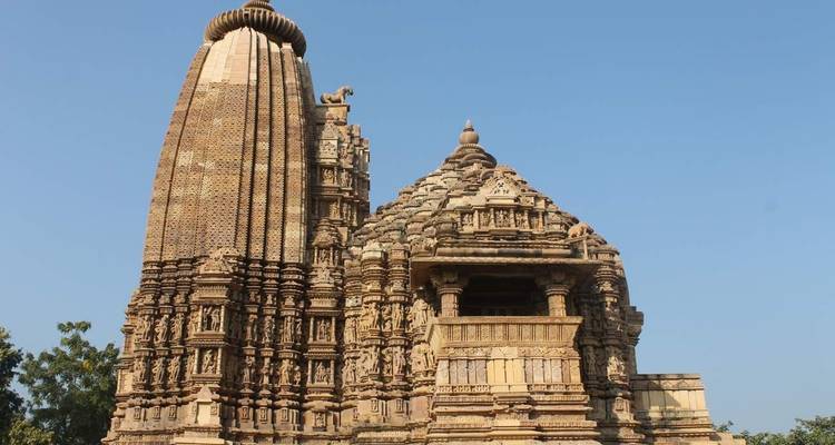 Ornately carved sandstone temple with a tall spire.