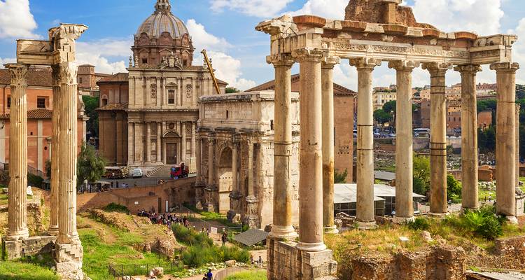 Roman Forum ruins with towering columns and baroque church dome under bright sky in Rome.