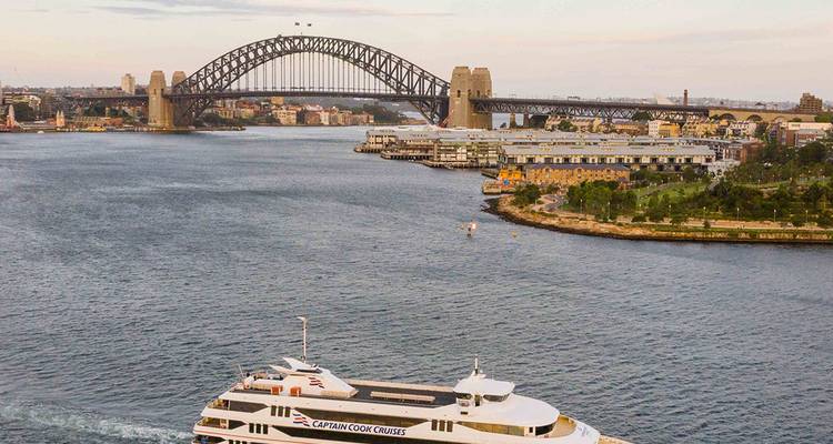 Sydney Harbour Bridge with a passenger cruise ship in the foreground.