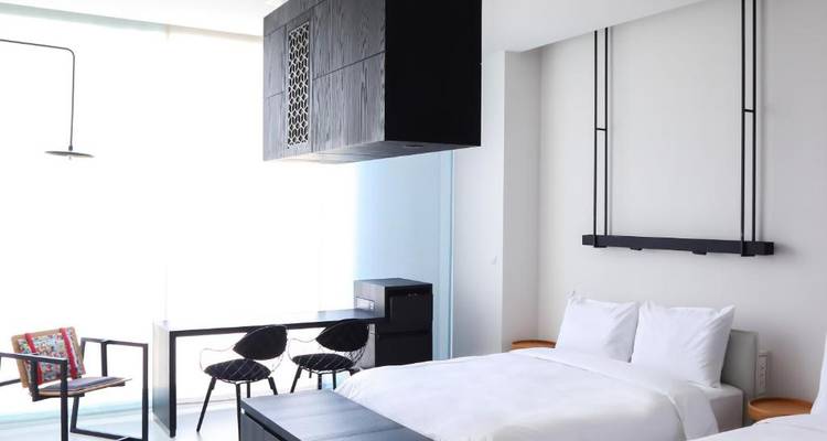 Chambre d'hôtel moderne avec mobilier et décoration minimalistes.