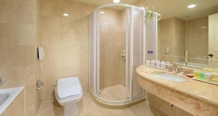 Lits jumeaux dans une chambre d'hôtel confortable avec éclairage décoratif.