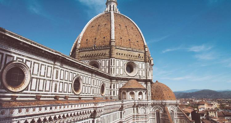 Close-up of Florence Cathedral's dome with a clear blue sky.