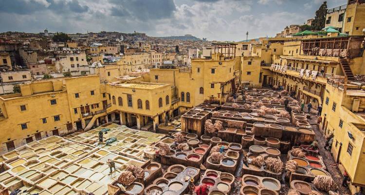 Vue à vol d'oiseau du complexe de tannerie animé de Chouara avec des ouvriers et des cuves de teinture à Fès.