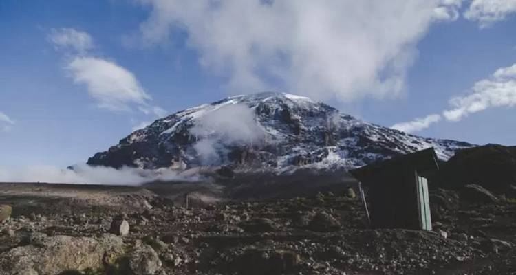 Snow-covered summit of a mountain with clear skies.