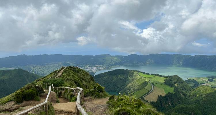 A panoramic view of a lush volcanic landscape with lakes.