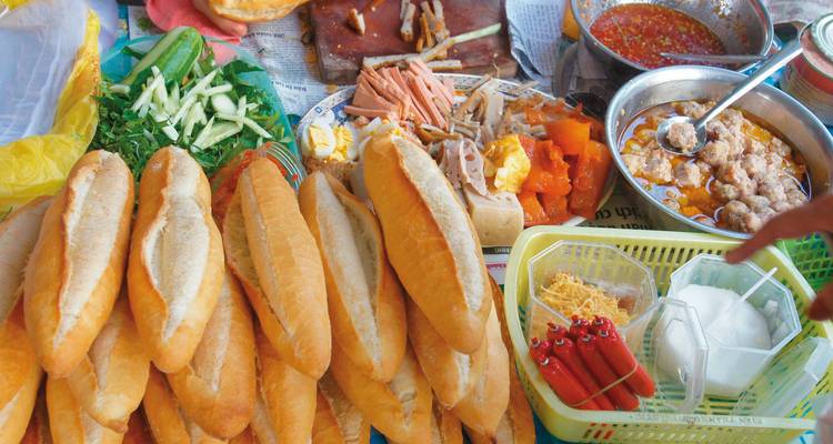 Street food scene with various dishes and condiments.