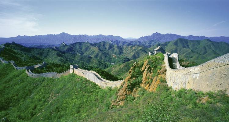 Great Wall of China traversing lush green mountains