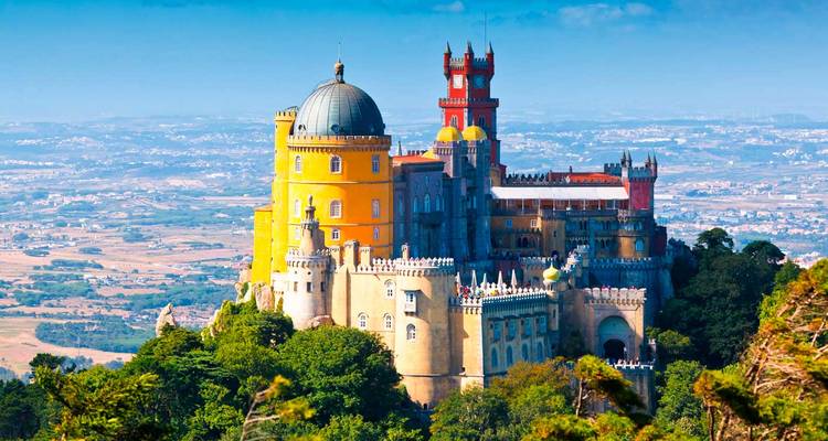 Colorful Pena Palace atop a hill with panoramic views.
