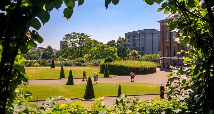 People enjoying a sunny day in a lush garden
