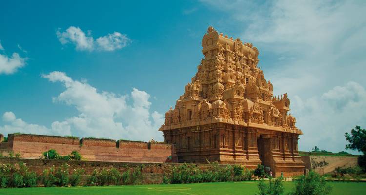 Elaborate temple with intricate carvings and a clear sky.