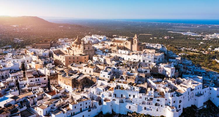 Aerial view of a historic Mediterranean town with whitewashed buildings.