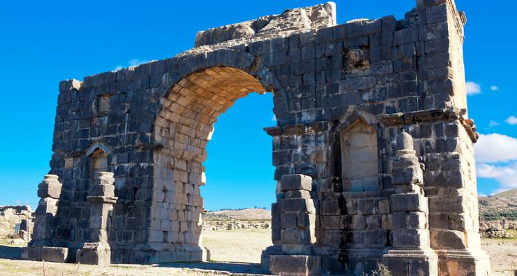 Ancienne arche de pierre avec ciel bleu.