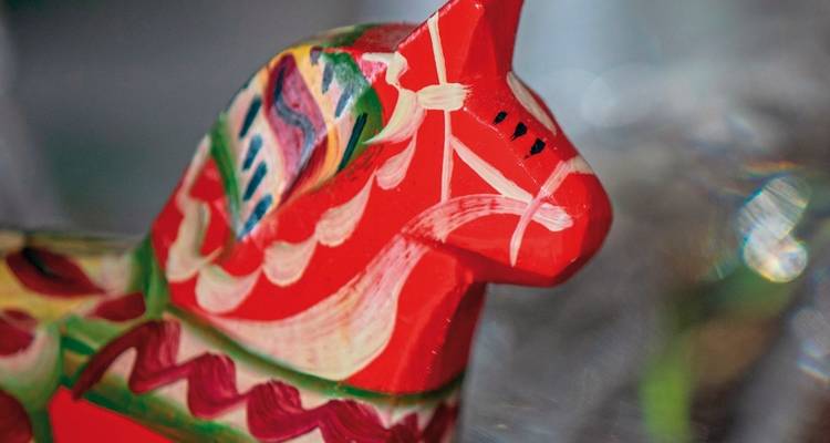 Close-up of a colorful traditional wooden horse figure.