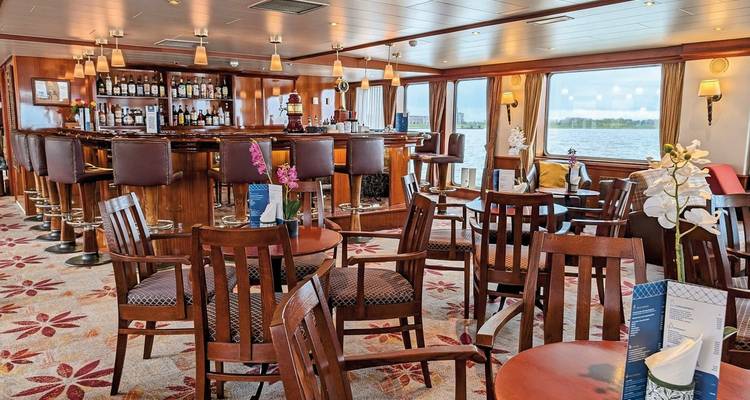 Bar lounge area on a cruise ship with seating.