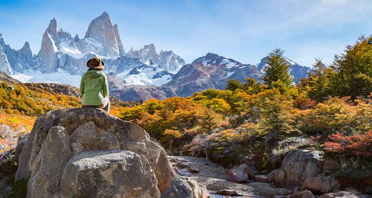 Person on a rock in front of Mount Fitz Roy.