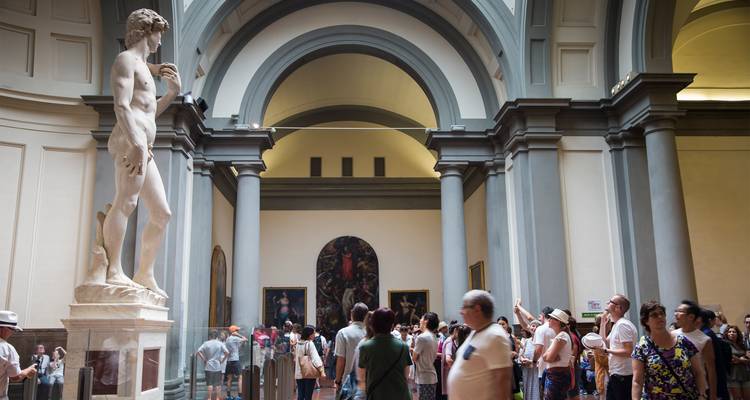 Visitors gather around Michelangelo's David inside Florence's Accademia Gallery.