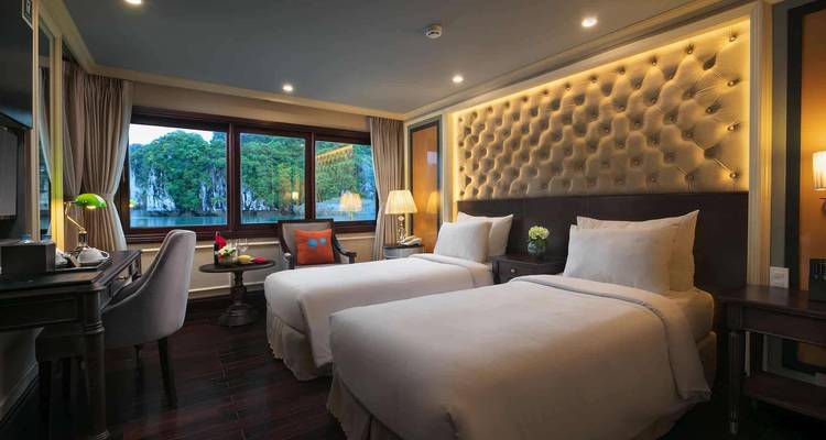 Hotel room with twin beds and a scenic window view.