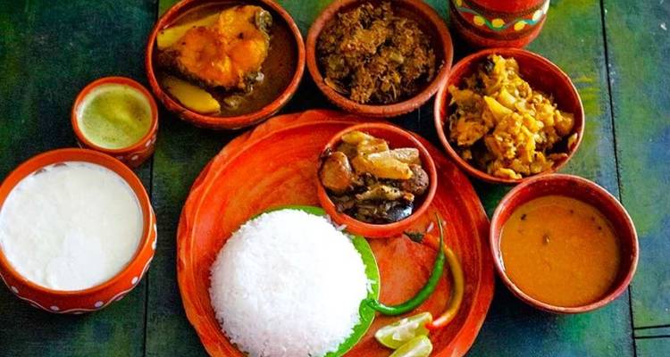 Traditional Indian meal served with various dishes on a wooden platter.