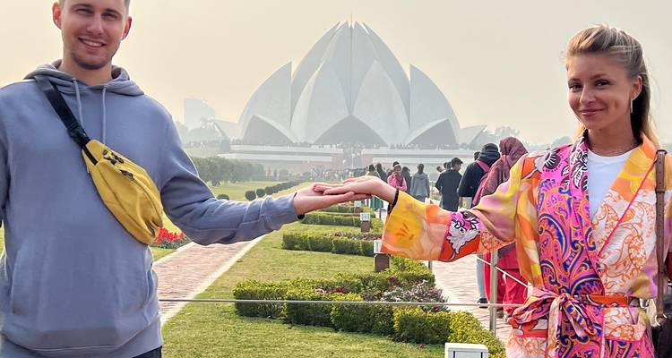 Couple posing with Lotus Temple in the background.