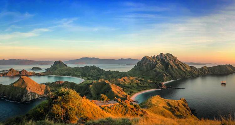 Idyllic landscape featuring lush hills and coastal waters.