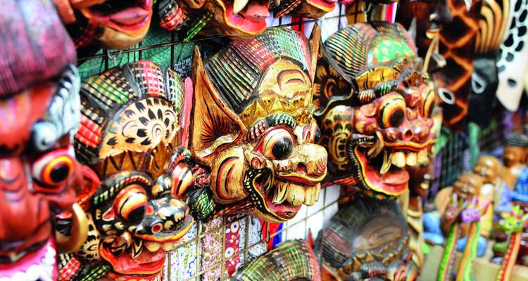 Intricately designed traditional masks displayed for sale.