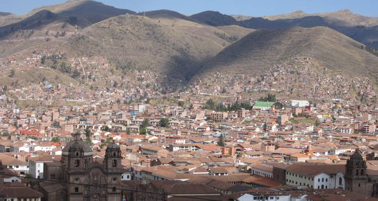Panoramic view of a cityscape with distant mountains.