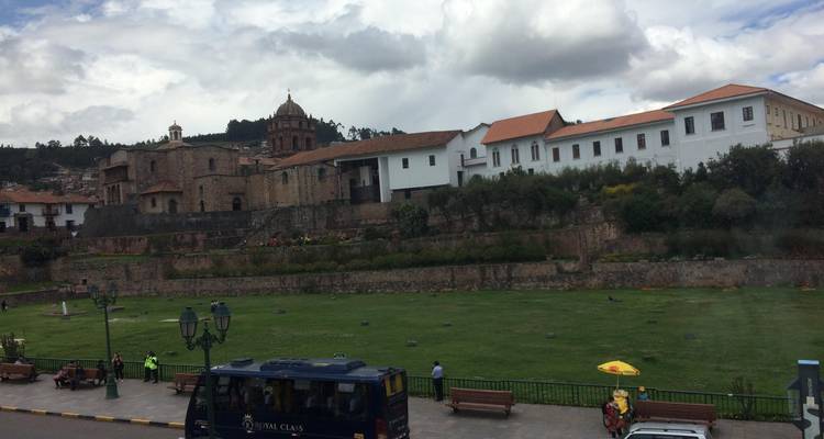 Historic buildings surrounding a green park area.