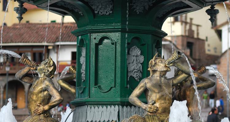 Fountain with ornate sculptures in a plaza.