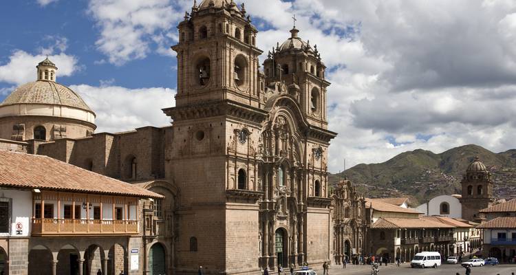 Grand baroque cathedral dominating Cusco’s Plaza de Armas with colonial arcades and Andean hills beyond.